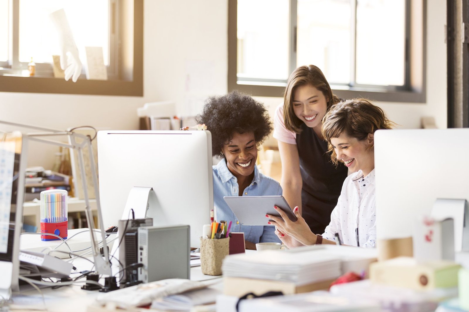 happy-businesswomen-using-digital-tablet-in-office-royalty-free-image-1624976289